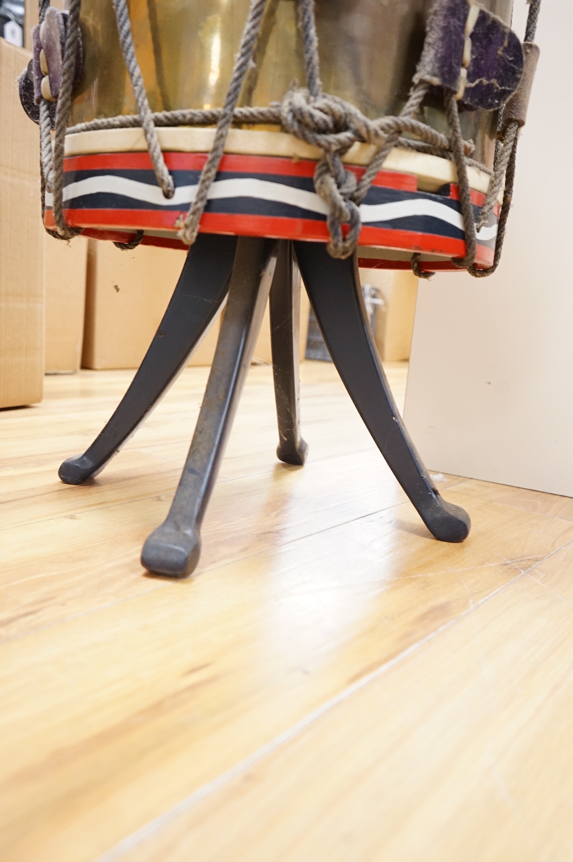 A red painted Regimental drum shaped table, 62cm high